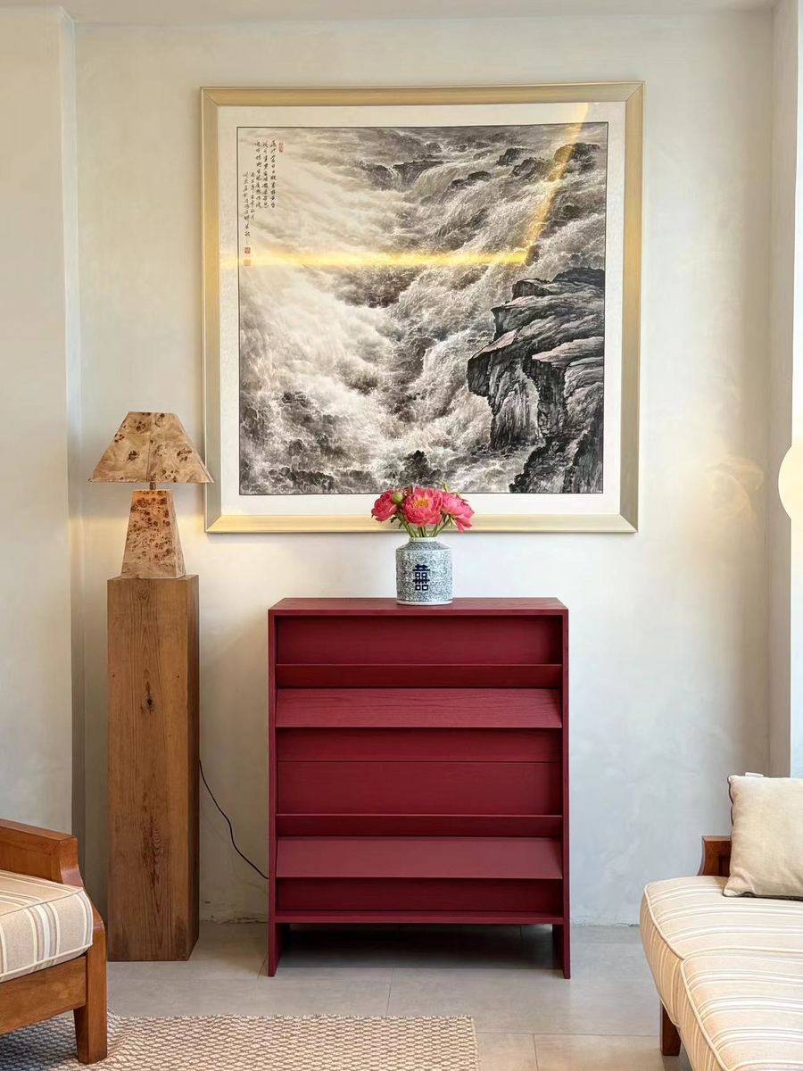 Tilt Chest in deep burgundy in a living room